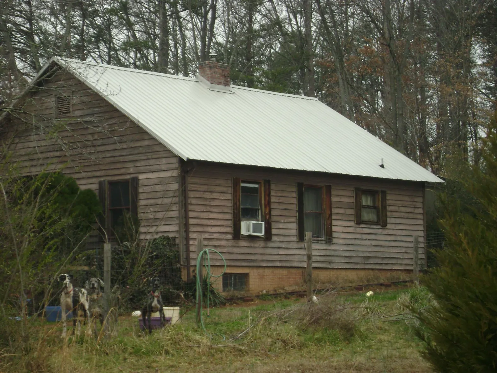 White metal roof on an old wood sided farmhouse, from a Metal Roof Installation job in New Columbia