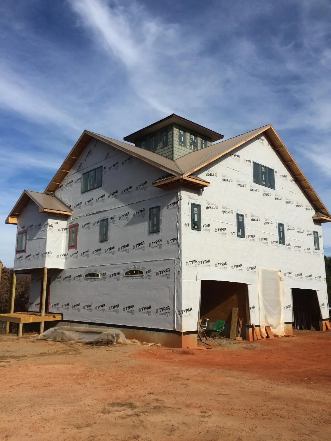 New two story house under construction with a cupola and gabled roofs in New Columbia
